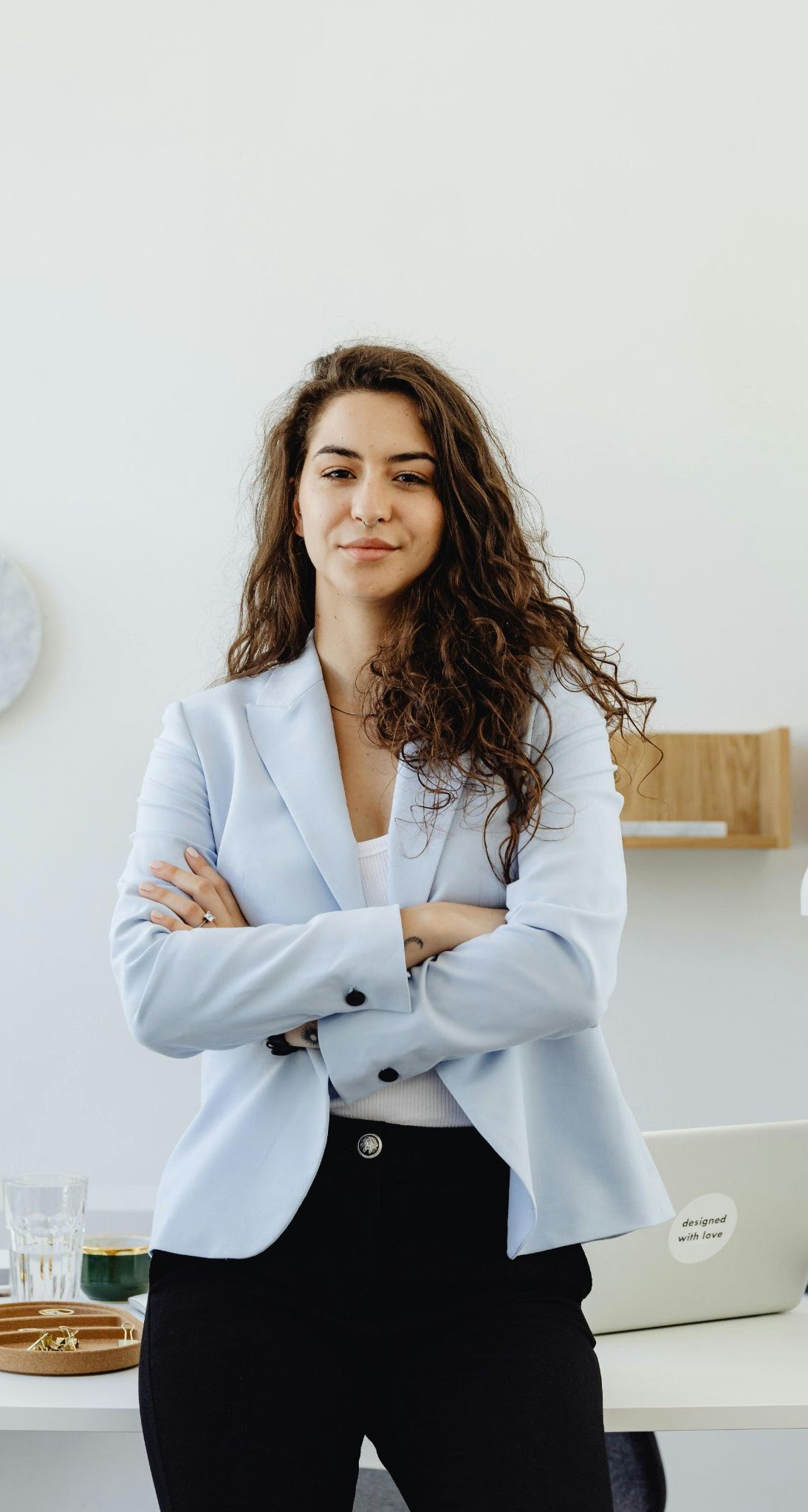 Confident businesswoman standing with folded arms